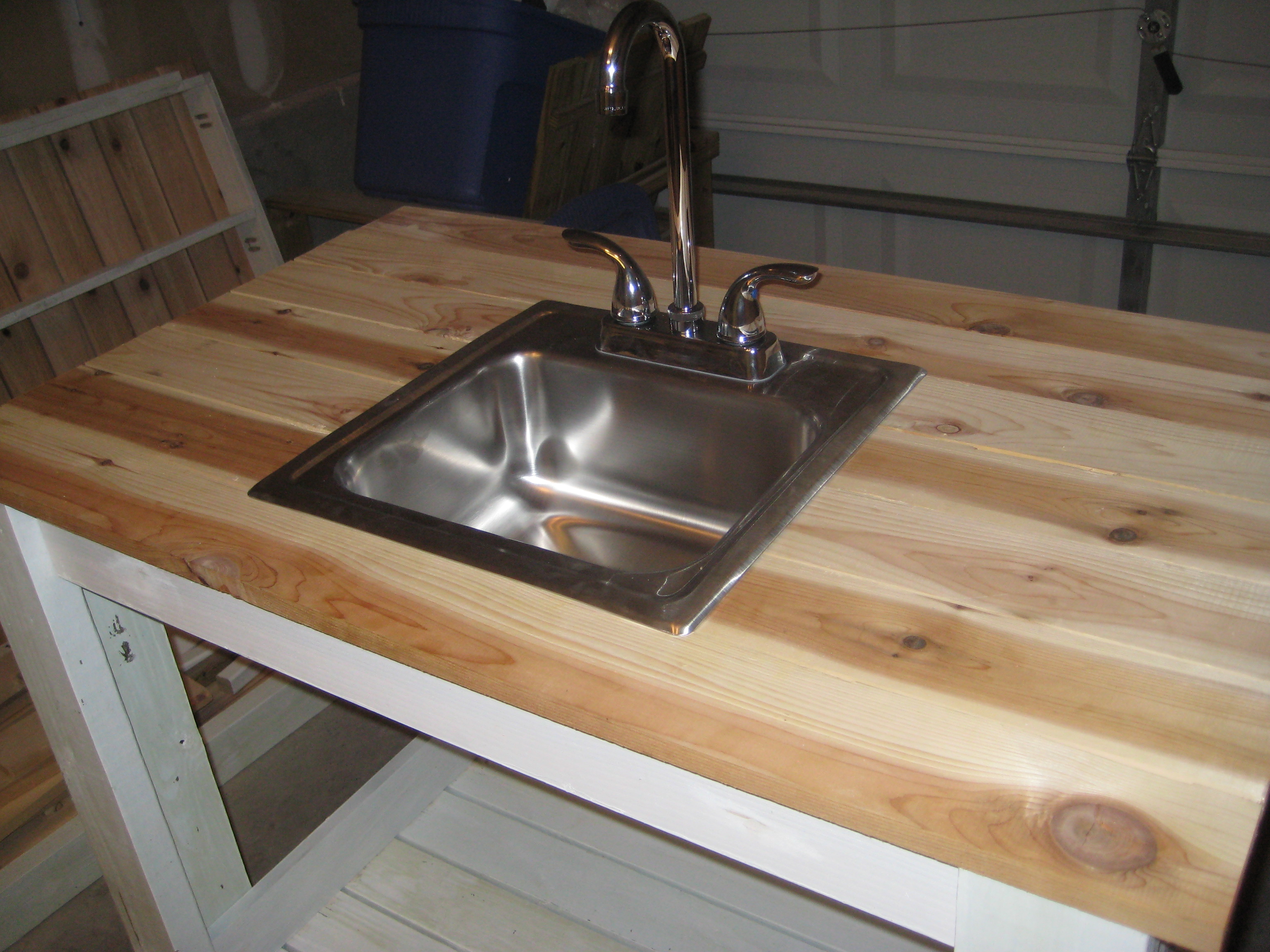 Outdoor sinks and outlet cabinets